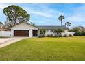Charming single-story home featuring a well-manicured lawn and a two car garage at 5321 Dover Ne St, St Petersburg, FL 33703