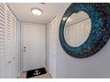 Cozy entryway featuring a decorative mirror and closet storage for a welcoming space at 6104 Palma Del Mar S Blvd # 404, St Petersburg, FL 33715