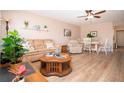 Comfortable living room with ceiling fan, neutral paint, and wood-look flooring at 1005 Rickenbacker Dr, Sun City Center, FL 33573