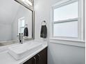 Modern bathroom with vessel sink, brushed nickel faucet, and large mirror, illuminated by natural light at 2246 Fiesta Dr, Sarasota, FL 34231