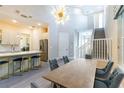 Open concept dining area featuring modern light fixture and staircase at 2246 Fiesta Dr, Sarasota, FL 34231