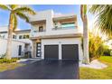 Contemporary two-story home with a two-car garage and modern architectural details at 2246 Fiesta Dr, Sarasota, FL 34231