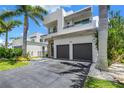 Modern, two-story home with a two-car garage and manicured landscaping at 2246 Fiesta Dr, Sarasota, FL 34231