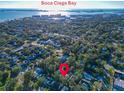Aerial view of a residential area near Boca Ciega Bay with lush greenery and a red pin marking the property location at 2514 Ohio S Ct, Gulfport, FL 33707