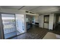 Bright living room featuring a sliding glass door and in-unit laundry at 27466 Us Highway 19 N # 97, Clearwater, FL 33761