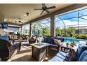 Covered outdoor living area featuring comfortable seating, an outdoor kitchen, and a view of the pool at 3815 Gaviota Dr, Sun City Center, FL 33573