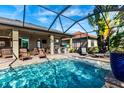 Screened-in pool with outdoor kitchen and plenty of lounge seating is perfect for Florida living at 3815 Gaviota Dr, Sun City Center, FL 33573