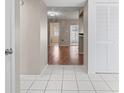 Welcoming hallway with neutral colors and tile flooring, leading to an open living space at 1033 Bowsprit Ln # 1406, Holiday, FL 34691