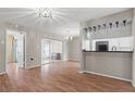 Open living space with wood flooring and sliding glass doors leading to the lanai at 1033 Bowsprit Ln # 1406, Holiday, FL 34691