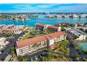 Expansive aerial view of waterfront condos, showcasing lush landscaping, water views, and community amenities at 8711 Blind Pass Rd # 307A, St Pete Beach, FL 33706