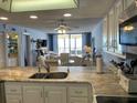 Bright kitchen showcasing granite countertops and open layout to living area with sliding glass doors to beach view at 20040 Gulf Blvd # 302, Indian Shores, FL 33785