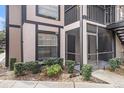 Exterior of condo with screened in porch and manicured landscaping at 3958 Dream Oak Pl # 104, Tampa, FL 33613