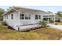 Charming home with updated windows, a covered entryway, and meticulously landscaped flower beds at 14912 Brookridge Blvd, Brooksville, FL 34613