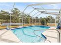 Sparkling swimming pool enclosed in a screened patio with a solar heater at 14912 Brookridge Blvd, Brooksville, FL 34613