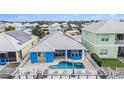 Aerial view showcases a private pool and deck, perfect for outdoor relaxation and entertaining, surrounded by lush landscaping at 6408 Key Island Ave, Apollo Beach, FL 33572