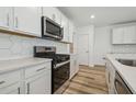 Modern kitchen showcasing stainless steel appliances and white cabinetry at 6690 Michael Favor Way, Wesley Chapel, FL 33545