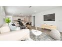 Bright, open-concept living room with modern furnishings and stylish decor at 6690 Michael Favor Way, Wesley Chapel, FL 33545