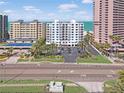 Condo exterior featuring parking, green space and tennis court at 1350 Gulf Blvd, Clearwater, FL 33767
