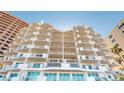 View of a modern condominium exterior with staggered balconies and glass railings offering stunning views at 1350 Gulf Blvd, Clearwater, FL 33767