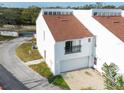 Charming two-story townhouse featuring a one car garage, and a balcony at 9406 Citrus Glen Pl, Tampa, FL 33618