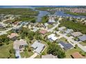 Enjoy the community from this aerial view of the neighborhood with lush greenery and waterways at 4514 Dewey Dr, New Port Richey, FL 34652
