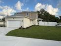 View of home, grass lawn and white fence bordering the back yard at 11594 Oak Ln, Largo, FL 33778