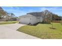 Charming two-story home with a paved driveway, attached garage, and well-manicured lawn at 11594 Oak Ln, Largo, FL 33778