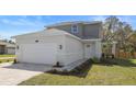 Charming two-story home with a two-car garage, landscaped front yard, and inviting walkway to the front door at 11594 Oak Ln, Largo, FL 33778