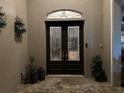 Elegant double front doors with decorative glass panels create a grand entrance to the home at 10626 Restoration Ter, Bradenton, FL 34212