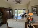 Inviting living room with sliding glass doors that offer a view of the sparkling swimming pool at 10626 Restoration Ter, Bradenton, FL 34212