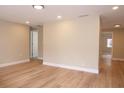 Bright living room with wood-look flooring, recessed lighting, and neutral wall colors at 7160 Lenape Cir, New Port Richey, FL 34653
