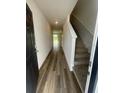 Inviting entryway featuring luxury vinyl plank flooring and staircase with carpeted steps at 2754 Pearly Banks Dr, Bradenton, FL 34208