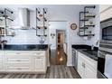 Stylish kitchen with stainless steel appliances, custom shelving, and elegant granite countertops at 1926 Burlington N Ave, St Petersburg, FL 33713