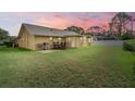 Spacious backyard features a patio with outdoor furniture and grill, great for entertaining at 1029 Falcon Ridge Ln, Palm Harbor, FL 34683