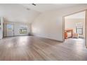 Bright living room showcasing hardwood floors, lots of natural light, and access to the Primary bedroom at 1029 Falcon Ridge Ln, Palm Harbor, FL 34683