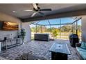 Covered patio with brick flooring, hot tub, ceiling fan, outdoor furniture and water view at 17671 Bright Wheat Dr, Lithia, FL 33547