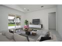 Bright living room featuring vaulted ceilings, tile floors, and sliding doors leading to backyard at 2972 Lake Saxon Dr, Land O Lakes, FL 34639