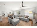 Bright living room with a large sectional sofa, ceiling fan, and hardwood flooring, with dining area views at 7001 Interbay Blvd # 313, Tampa, FL 33616