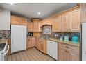 Updated kitchen featuring wood cabinets, granite countertops, and mosaic tile backsplash at 6327 2Nd S Ave, St Petersburg, FL 33707