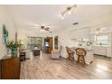Open-concept living room featuring hardwood floors, a ceiling fan, and a view of the screened-in porch at 1250 S Pinellas Ave # 713, Tarpon Springs, FL 34689