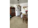 Cozy dining area featuring a traditional hutch and view into the kitchen, perfect for intimate meals at 5915 18Th N St # 12, St Petersburg, FL 33714