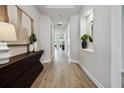 Bright hallway features recessed lighting, wood floors, and stylish decor at 6123 Hidden Branch Dr, Apollo Beach, FL 33572