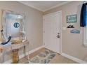 Entryway featuring tile flooring, decor, and a white front door at 18325 Gulf Blvd # 407, Redington Shores, FL 33708