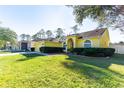 Charming one-story home with a well-manicured lawn and verdant landscaping for great curb appeal at 5215 New Brittany Ln, Zephyrhills, FL 33541