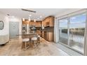 Bright kitchen featuring travertine tile, granite counters, and a center island with breakfast bar seating at 8829 Bay Pointe Dr # 205, Tampa, FL 33615