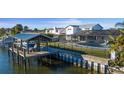 Waterfront backyard features a large private dock with a boat and a screened-in pool at 8716 Hickorywood Ln, Tampa, FL 33615