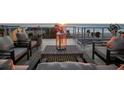 Relaxing rooftop patio with comfortable seating and ocean views at sunset at 8750 Harrell Ave, Treasure Island, FL 33706