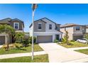 Charming two-story home with a well-manicured lawn and a two-car garage at 16719 Delia St, Wimauma, FL 33598