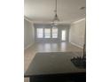 Bright and spacious living room featuring a tile floor, neutral color palette, and multiple windows for abundant natural light at 2588 Bartolo Dr, Land O Lakes, FL 34639
