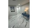 Hallway showcasing sleek flooring, calming wall decor, and a stylish console table at 6220 Westport Dr, Port Richey, FL 34668